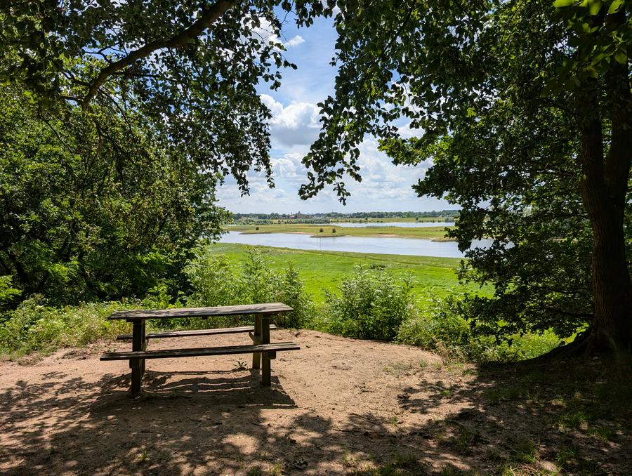 Picknick table atop the Noordberg, overlooking the Rhine, the village of Heteren and very far in the distance, the city of Nijmegen.