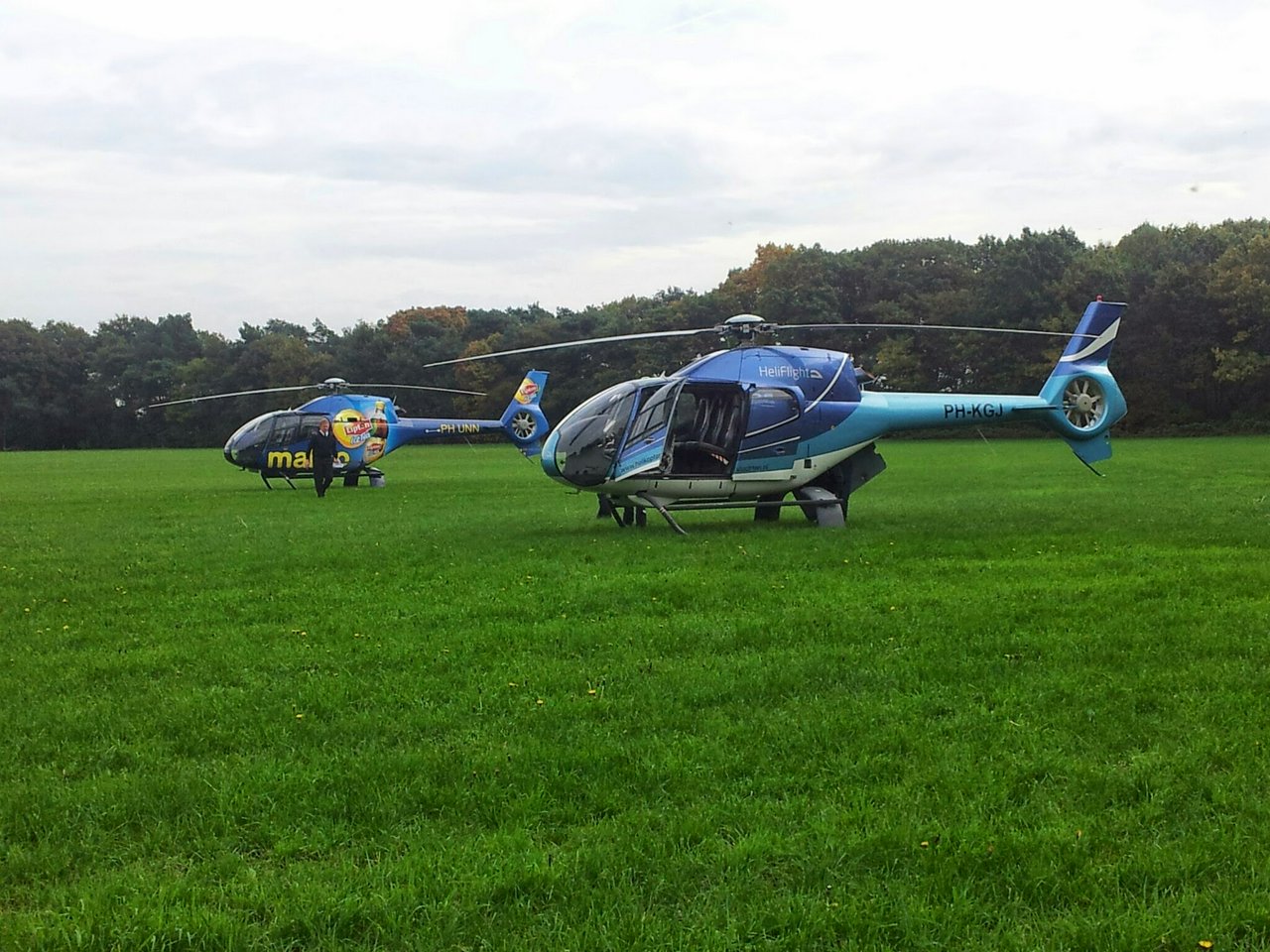 Two helicopters waiting for a business outing