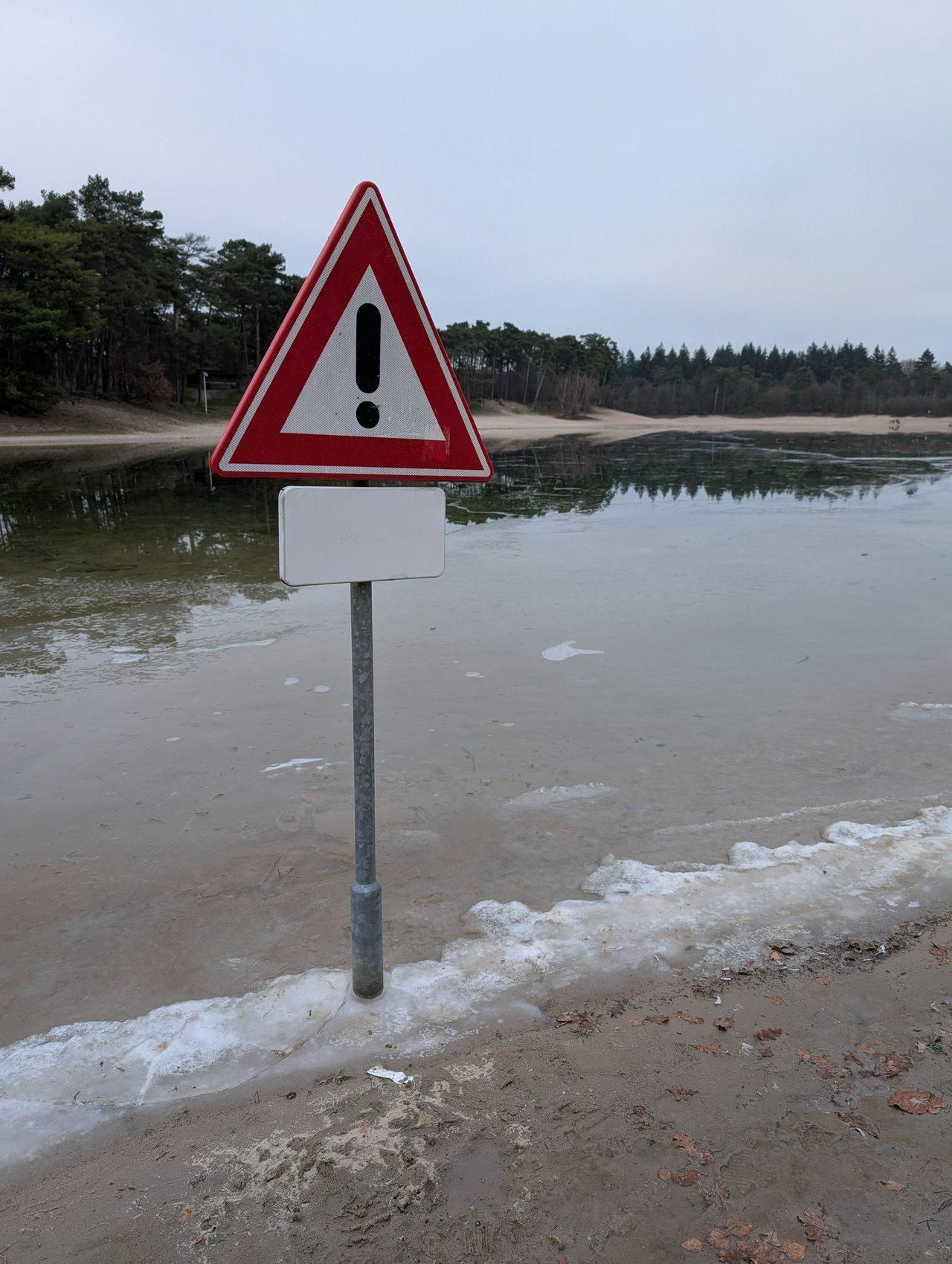Warning sign at a frozen Henschotermeer
