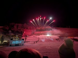 Watching a ski show at night, with red fireworks fanning out and golden sparkling trails.
