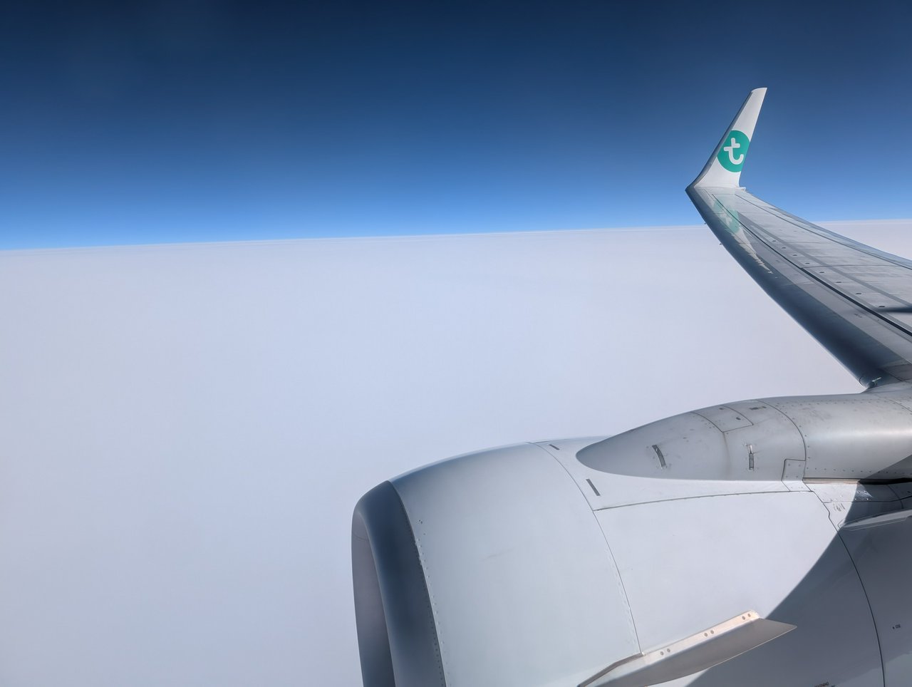 Obligatory "winglet over a white cloud blanket, with skyblue background" photo