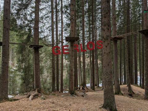 A sign spelling 'Gerlos' hangs in the trees
