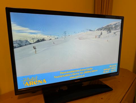 TV in hotel room showing live webcam of the slopes