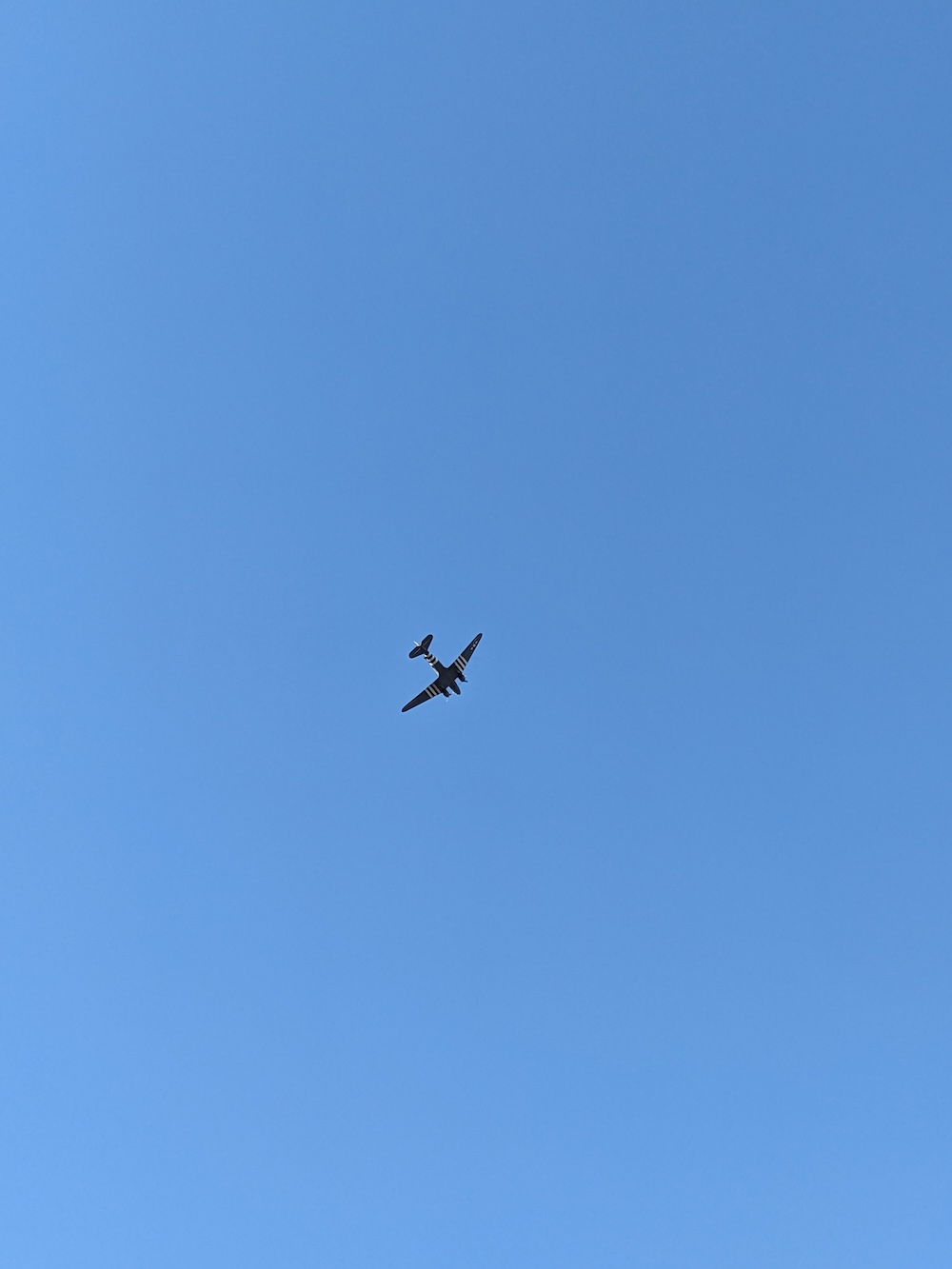 Dakota DC-3 (in military livery) flying over Ginkelse Heide as part of the 2024 Airborne Commemoration