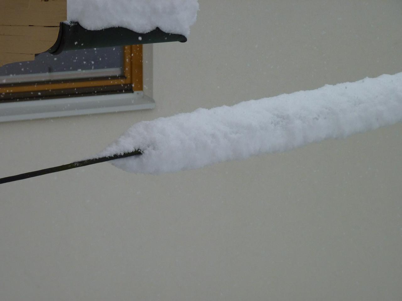 A lot of snow on a wire