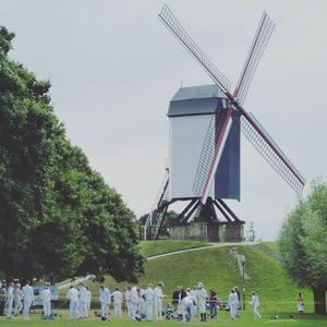 Fencers practicing near a windmill in Bruge.